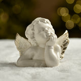 Winged angel figurine holding its chin with one hand