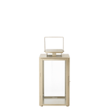 Lanterne en métal mat effet brossé doré avec anse carrée, dessus carré et plat. Avec fenêtres transparentes en verre. Structure dorée en acier inoxydable.