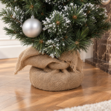 Détail de la base en toile de jute du sapin de Noël artificiel décoré vert 90 cm posé au sol
